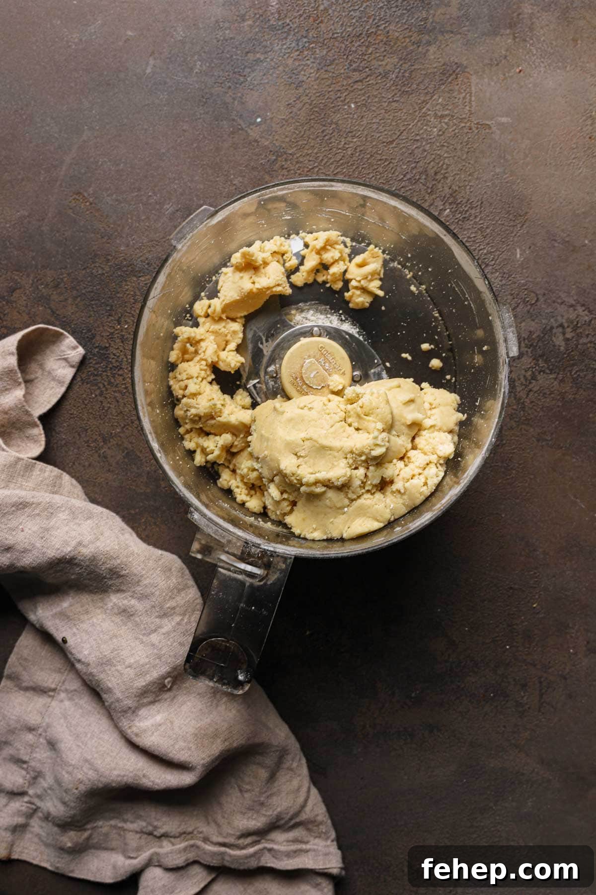 Italian Pasta Frolla Shortcrust Pastry: Multipurpose Dough Guide 6 A food processor bowl with pasta frolla dough.