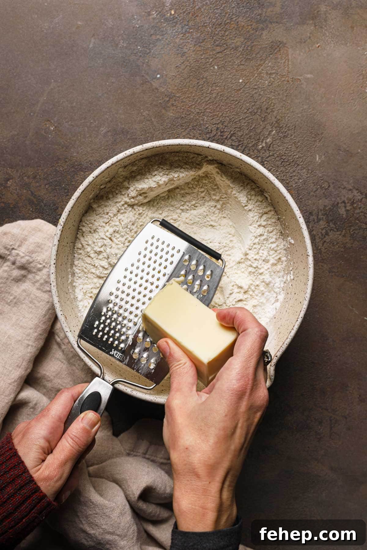 Italian Pasta Frolla Shortcrust Pastry: Multipurpose Dough Guide 8 A hand grating butter into a large bowl with flour.