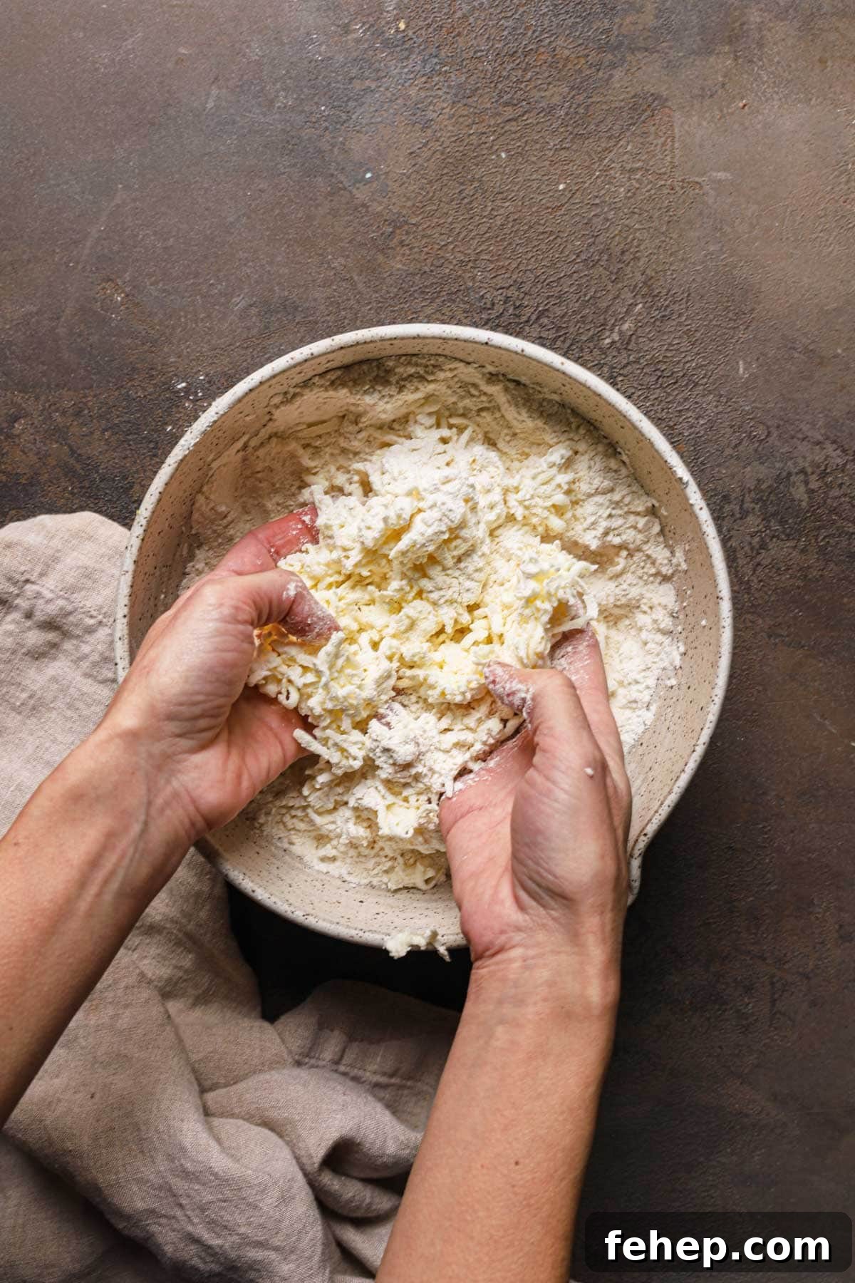 Italian Pasta Frolla Shortcrust Pastry: Multipurpose Dough Guide 9 Hands rubbing butter into flour in a large bowl.