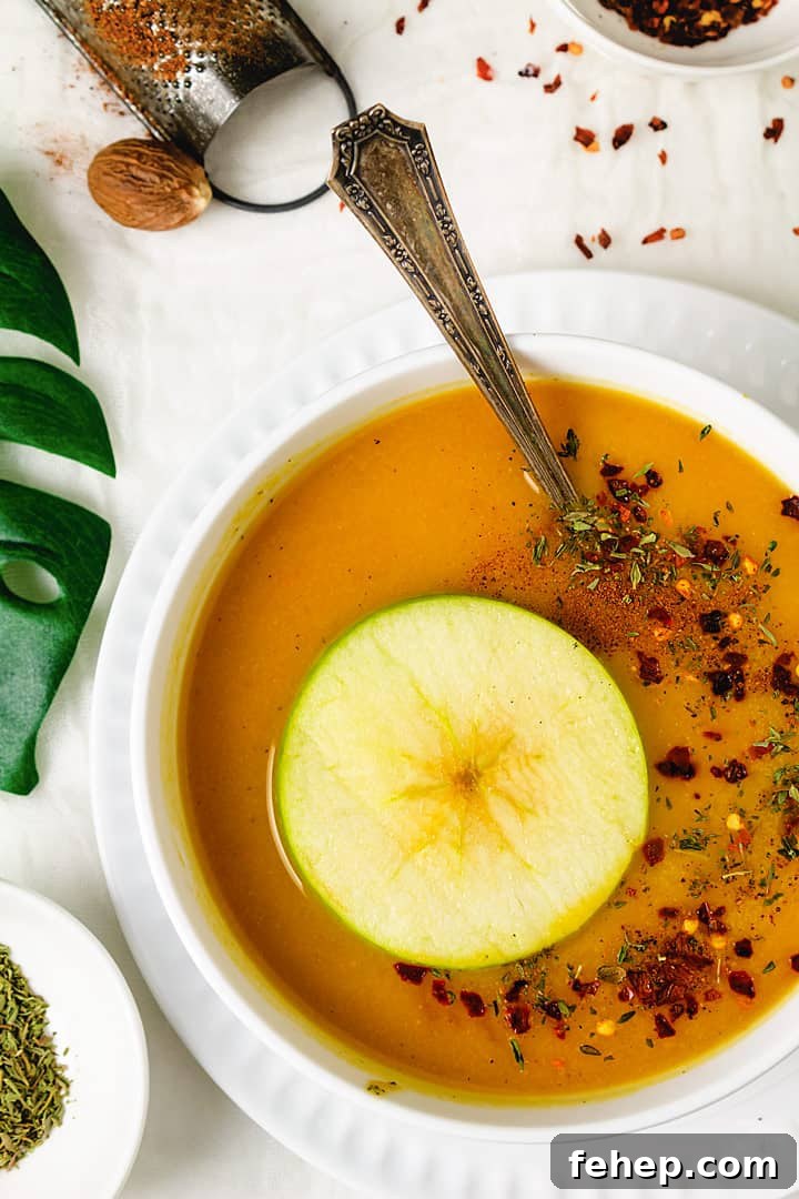 Butternut Squash and Apple Soup Recipe for Cozy Fall Nights 2 Squash soup with an apple ring and spices.