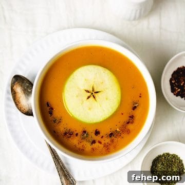Butternut Squash and Apple Soup Recipe for Cozy Fall Nights 7 Overhead view of the dish in a bowl, spices, and salt and pepper shaker