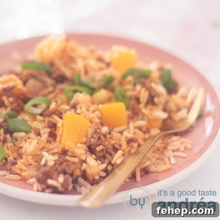 A square photo with rice, minced meat and peach on a pink plate