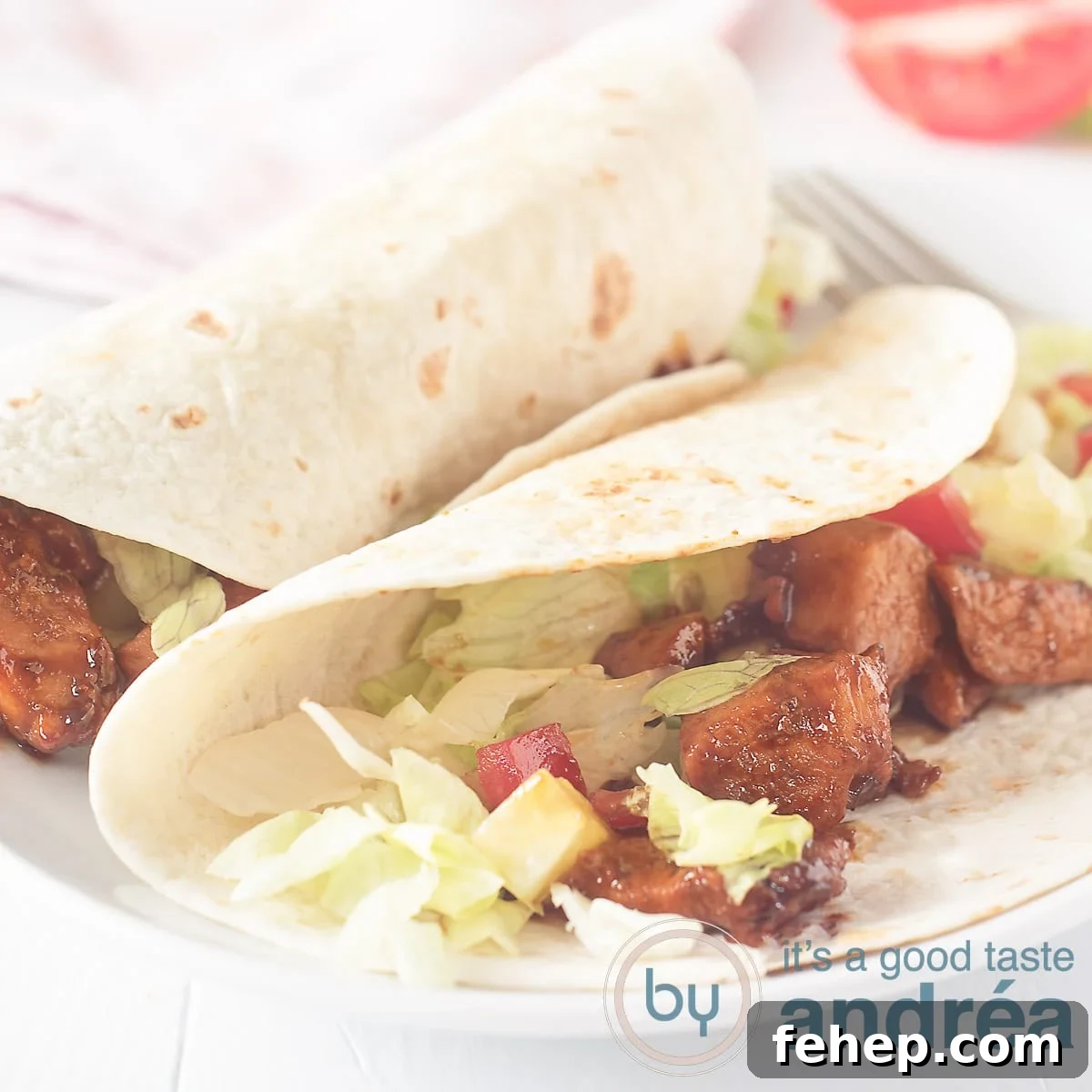 Soy Chicken Wrap Recipe: Flavorful Plant-Based Lunch Ideas 5 A square photo with two wraps rolled up, 1 half opened with soy sauce, lettuce, tomato on a white background.
