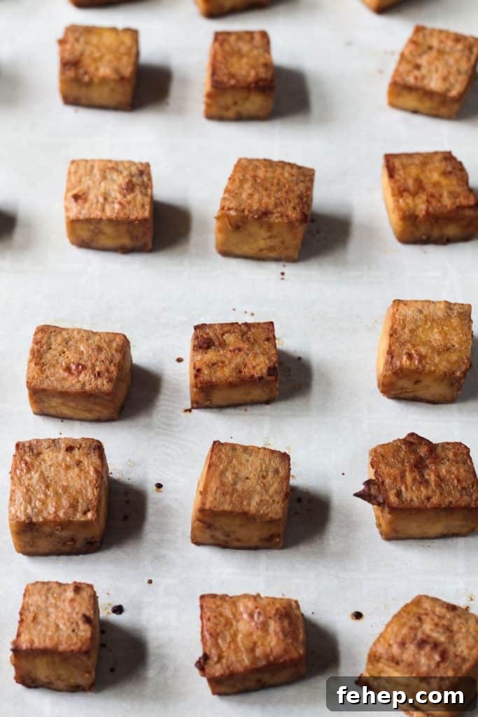 Flavorful Marinated Baked Tofu Recipe for Crispy, Savory Tofu 7 Oven baked tofu with crispy edges on parchment paper