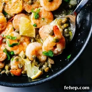 Shrimp Piccata on a spoon in a skillet.