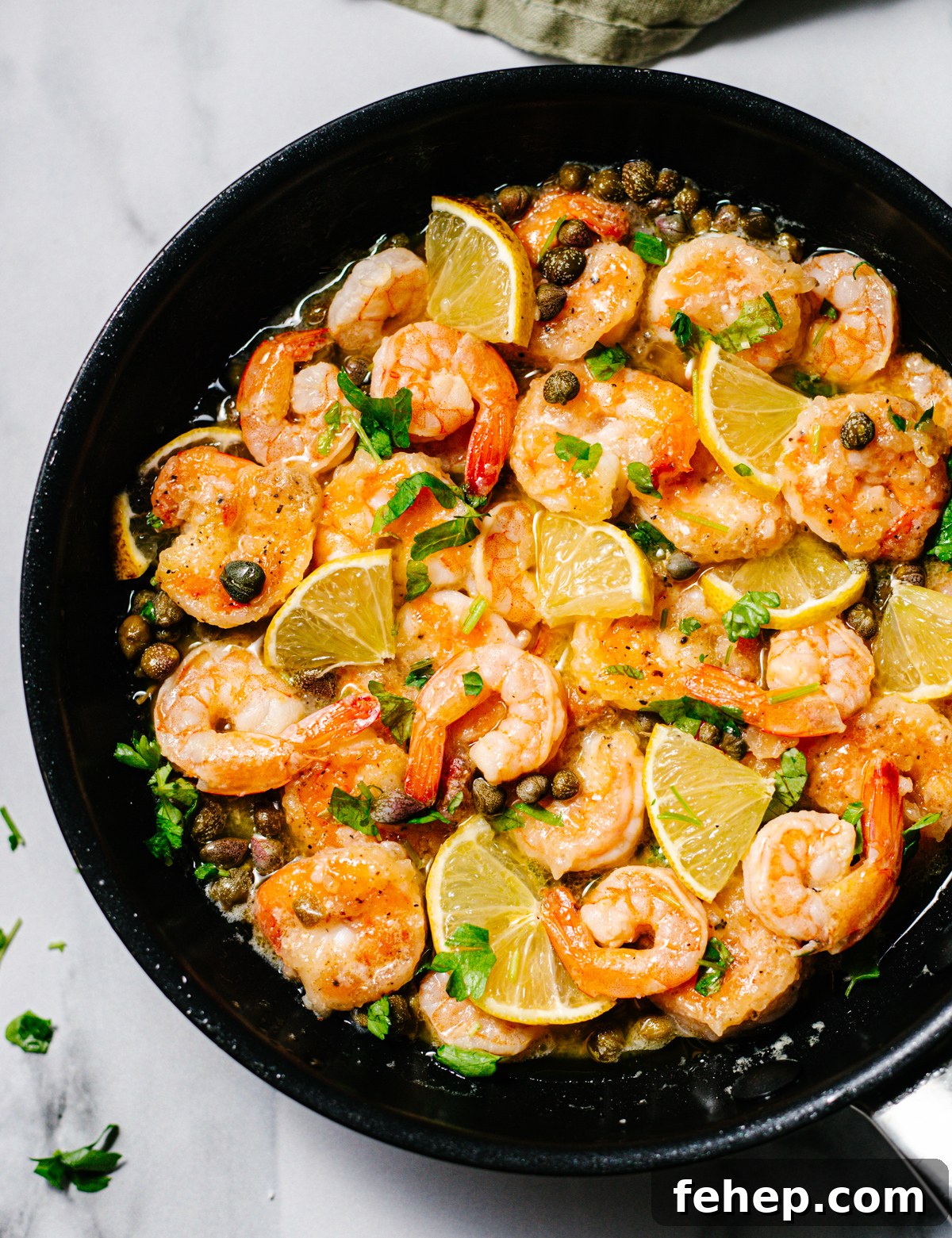 Shrimp Piccata in a skillet photographed from above.