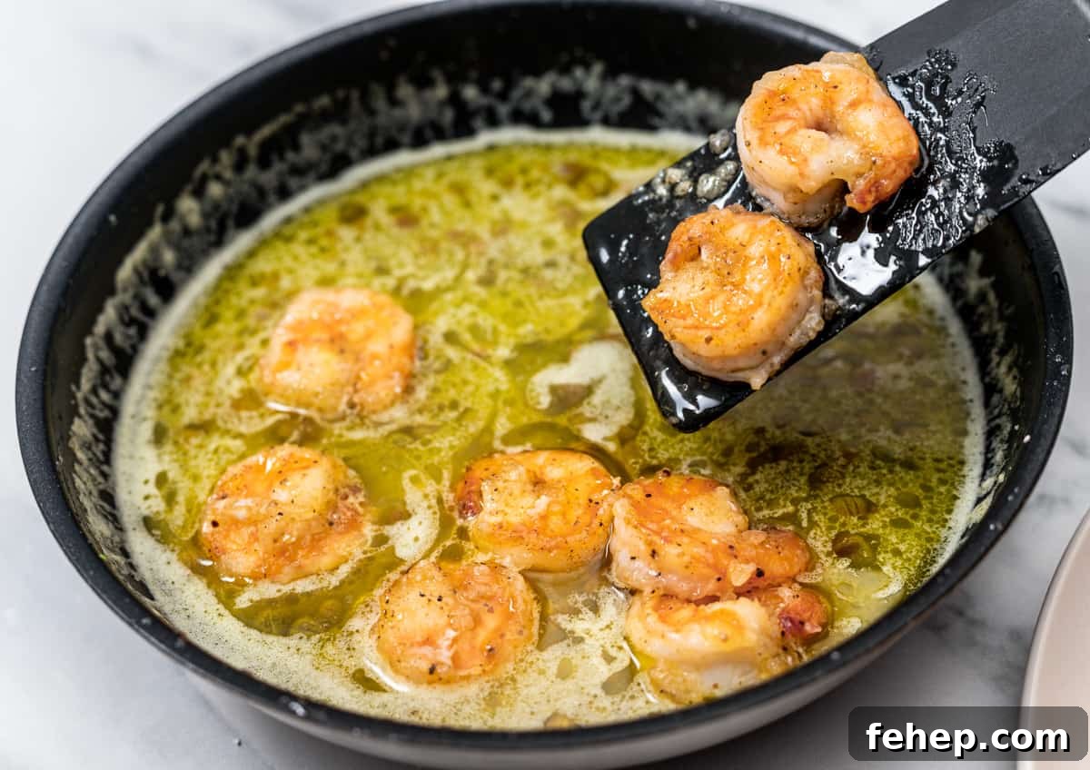returning shrimp to sauce in skillet.
