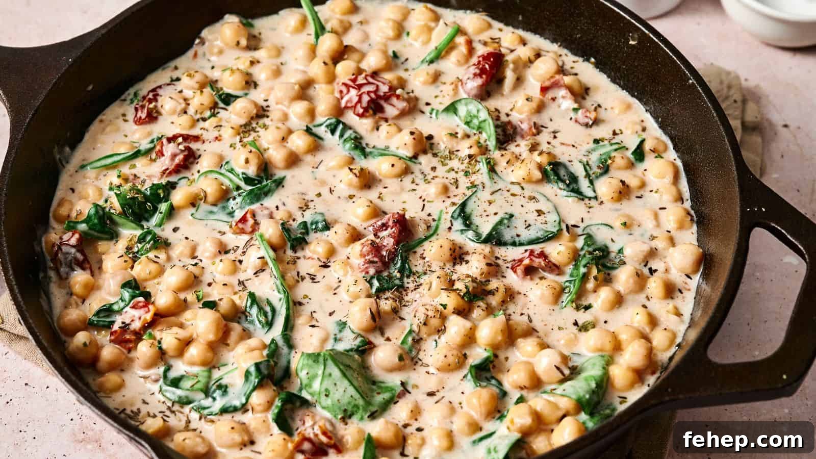 11 Marry Me Recipes That Impress Without Fuss 6 Skillet with creamy chickpeas, spinach, and sun-dried tomatoes, garnished with herbs.