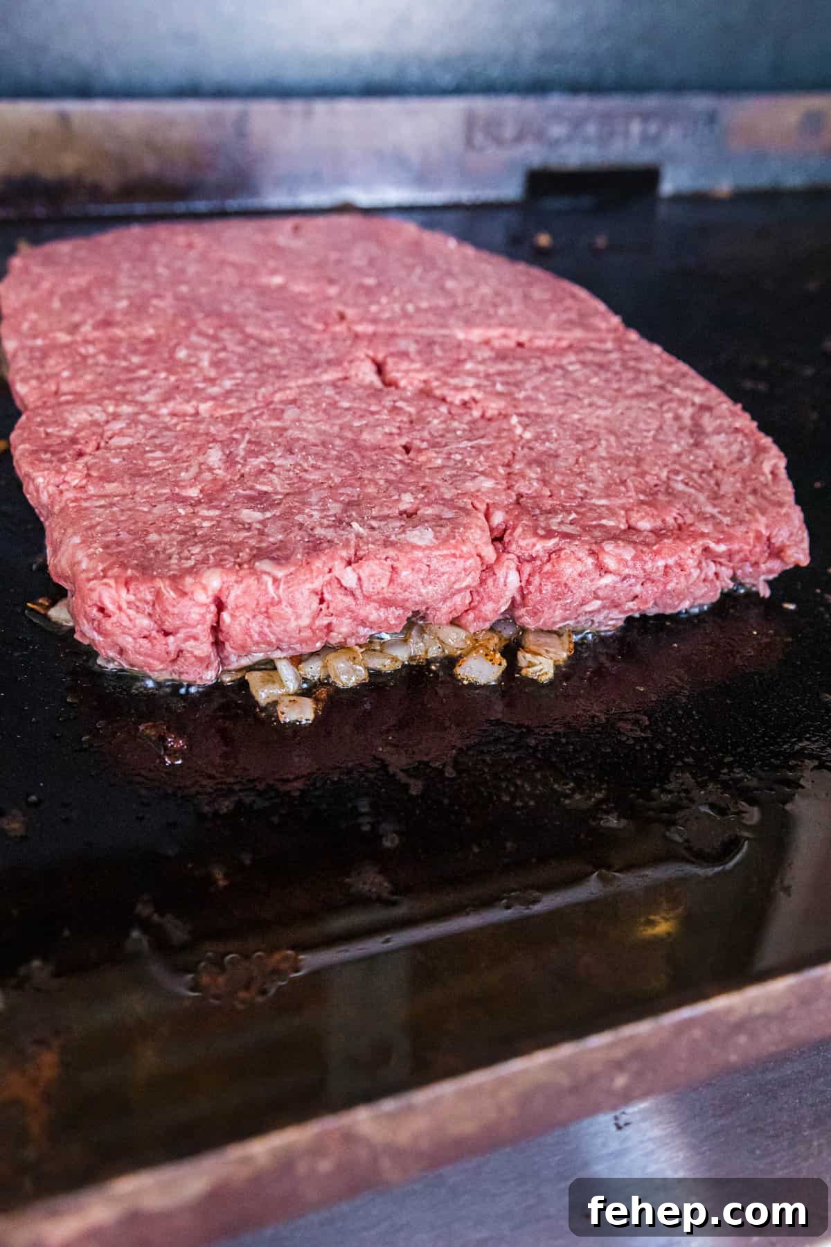 Topping Onions with Ground Beef for Blackstone Bacon Cheeseburger Sliders