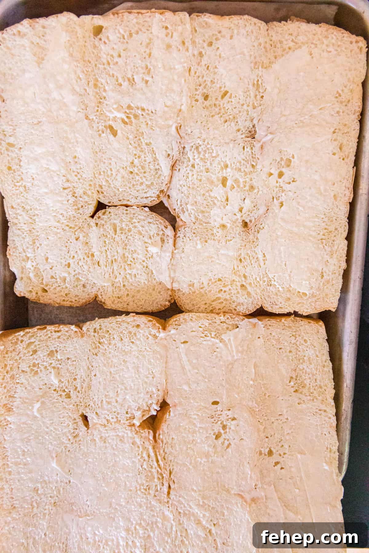Buttering Hawaiian Rolls for Blackstone Bacon Cheeseburger Sliders