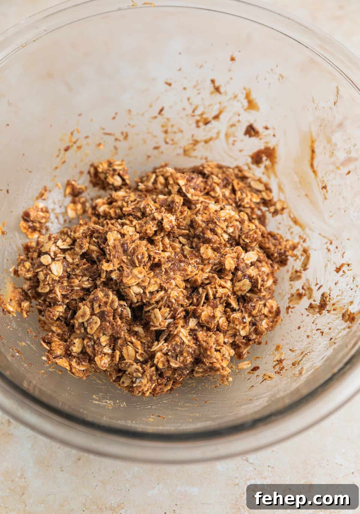 Oat and peanut butter ball mixture in glass bowl.