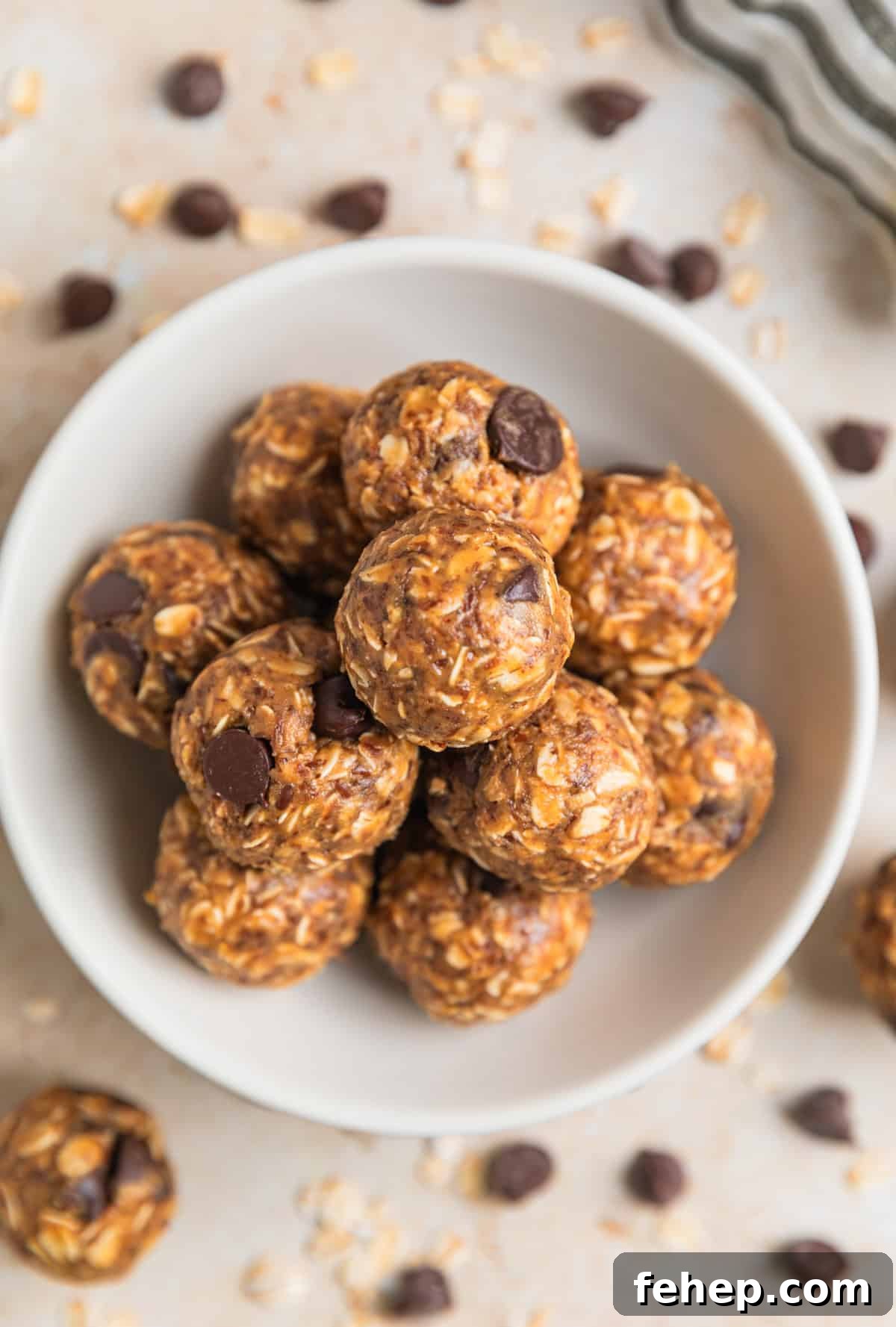 Dish with peanut butter oatmeal balls with dark chocolate chips.