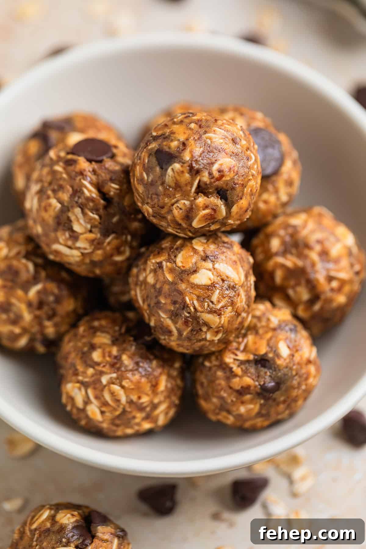 Close up view of oat and peanut butter balls in white dish.