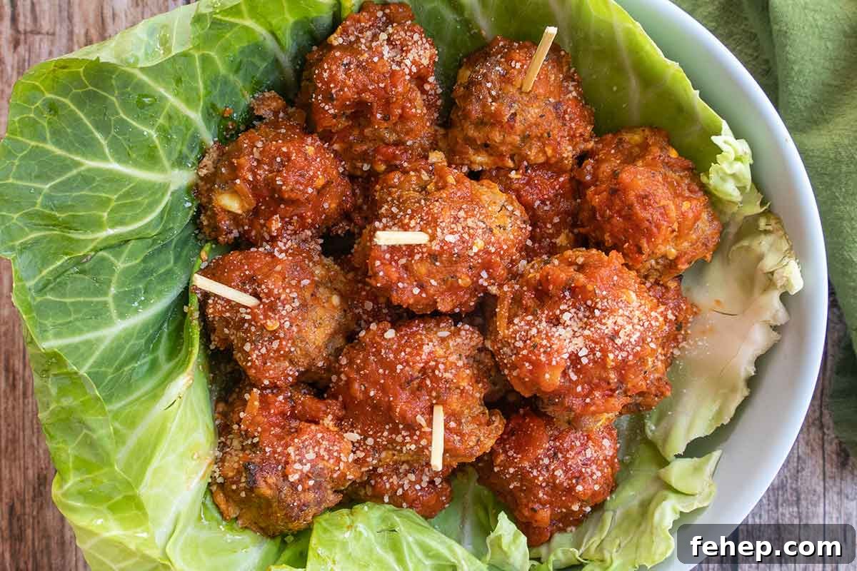 26 Addictive Gluten-Free Game Day Recipes Fans Devour 13 baked Italian meatballs in a bowl lined with cabbage leaf