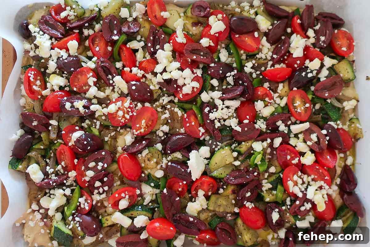 26 Addictive Gluten-Free Game Day Recipes Fans Devour 15 Flatbread-batter-topped-with-veggies-and-feta-in-a-rimmed-baking-sheet-ready-for-the-oven