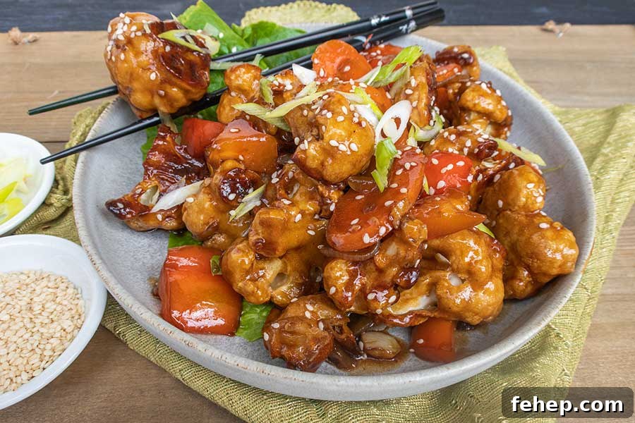 26 Addictive Gluten-Free Game Day Recipes Fans Devour 20 Gluten free Vegetarian Kung Pao Cauliflower with sauce on a plate