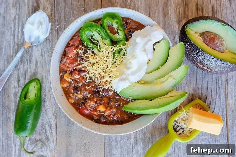 26 Addictive Gluten-Free Game Day Recipes Fans Devour 6 black bean chili topped with avocado and sour cream in a bowl
