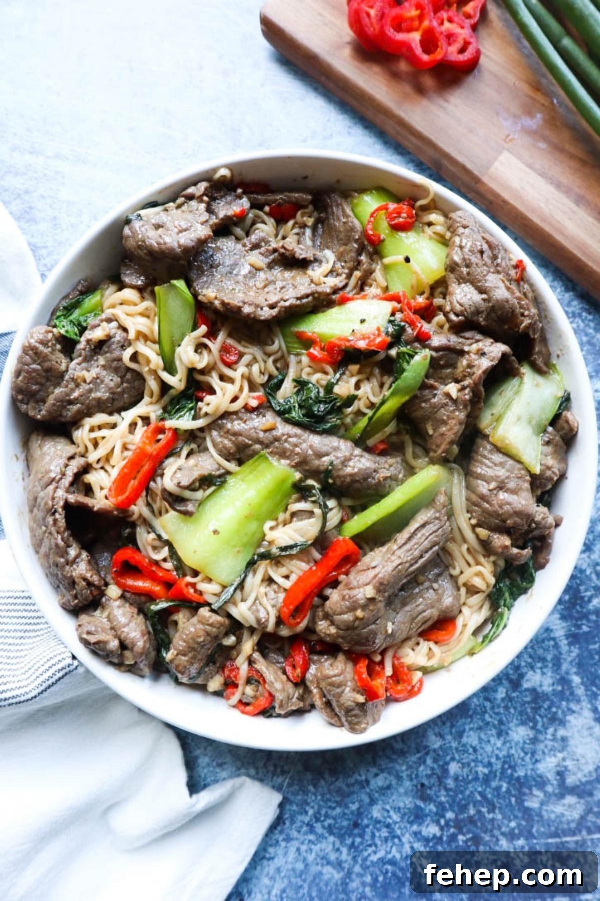 Stir-Fried Vietnamese Pho with Beef and Noodles 2 white plate with noodles, vegetables, and beef.