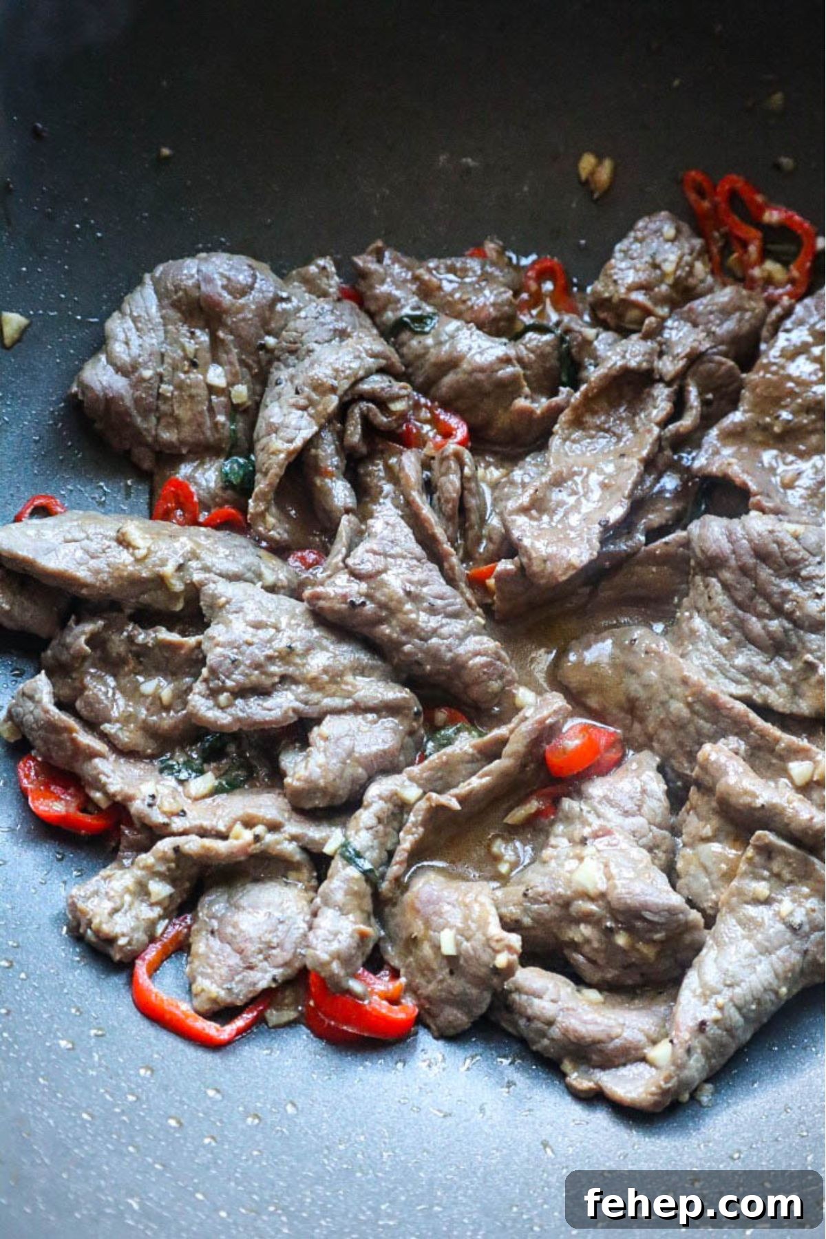 Stir-Fried Vietnamese Pho with Beef and Noodles 4 beef cooked with red chilis in wok.