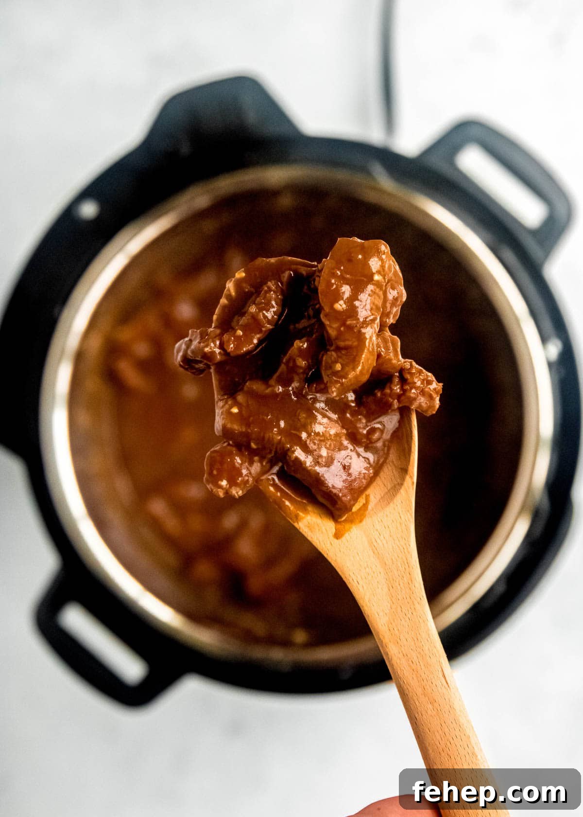Instant Pot Mongolian Beef Recipe — Tender, Savory Weeknight Meal 7 mongolian beef in instant pot close up with wooden spoon