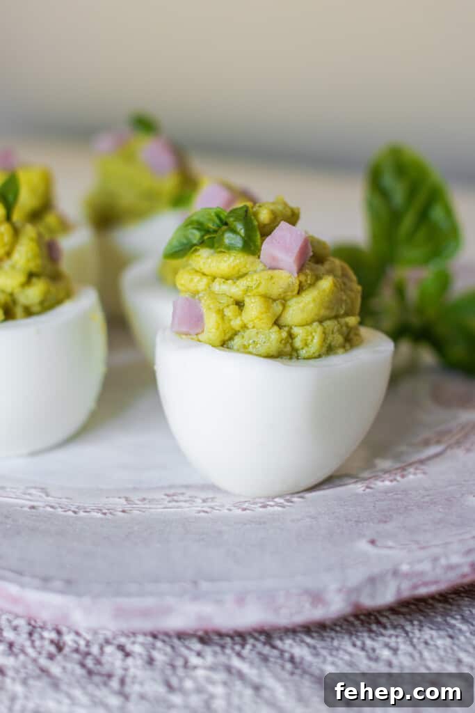 The Deviled Eggs Recipe You’ll Make Again and Again 2 Deviled eggs on light plate
