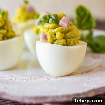 The Deviled Eggs Recipe You’ll Make Again and Again 8 Deviled eggs on light plate