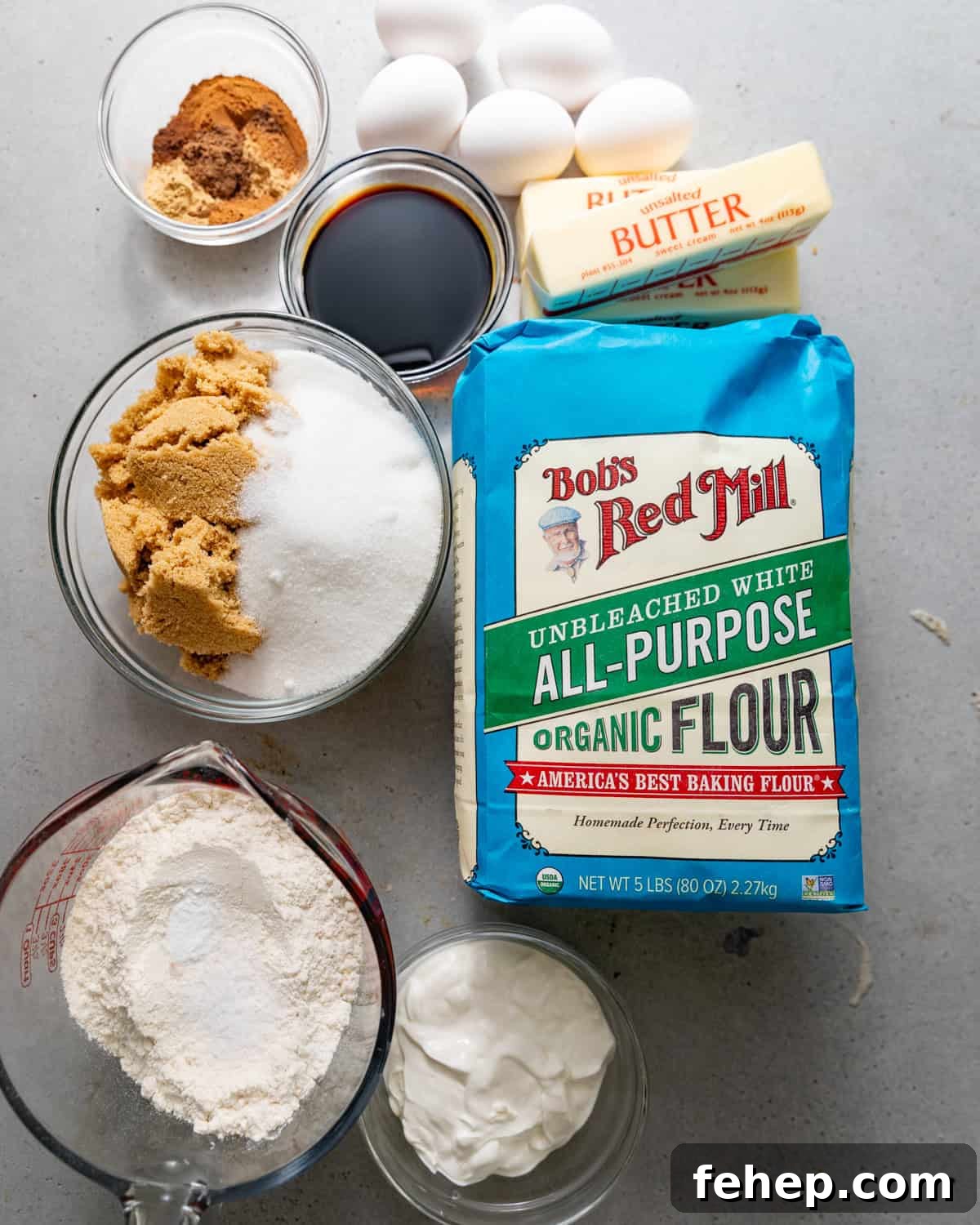 ingredients to make gingerbread bundt cake on a white surface.
