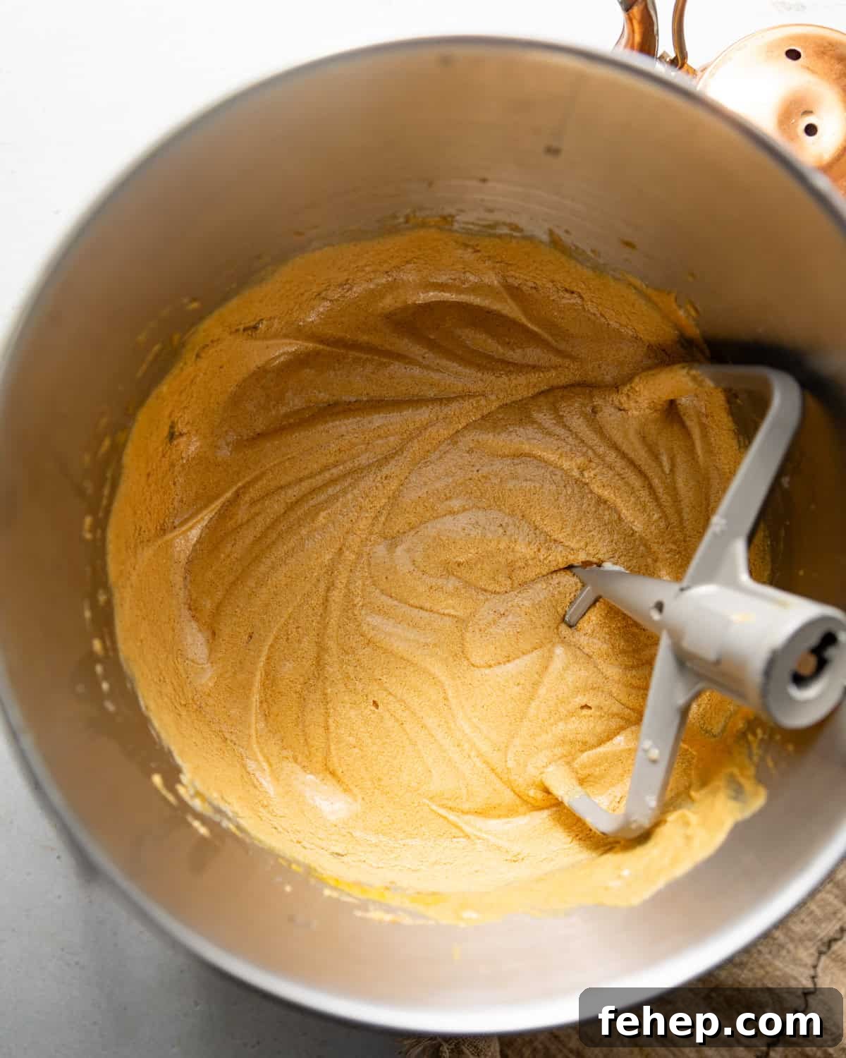 wet ingredients in the bowl of a stand mixer mixed together with the paddle attachment.