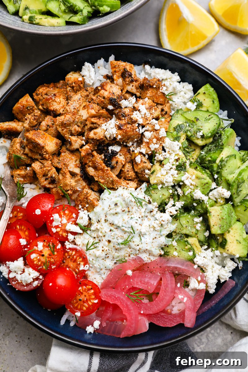Tzatziki chicken bowls made with diced marinated chicken thighs, cucumber-avocado salad, pickled onions, tomatoes and homemade tzatziki