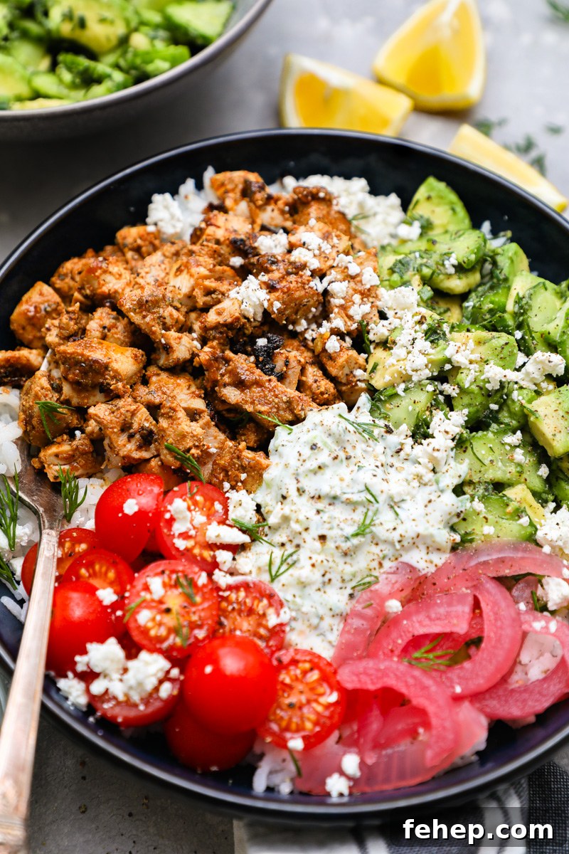 A close up photo of spiced and marinated chicken thighs chopped up and used in a tzatziki chicken bowl