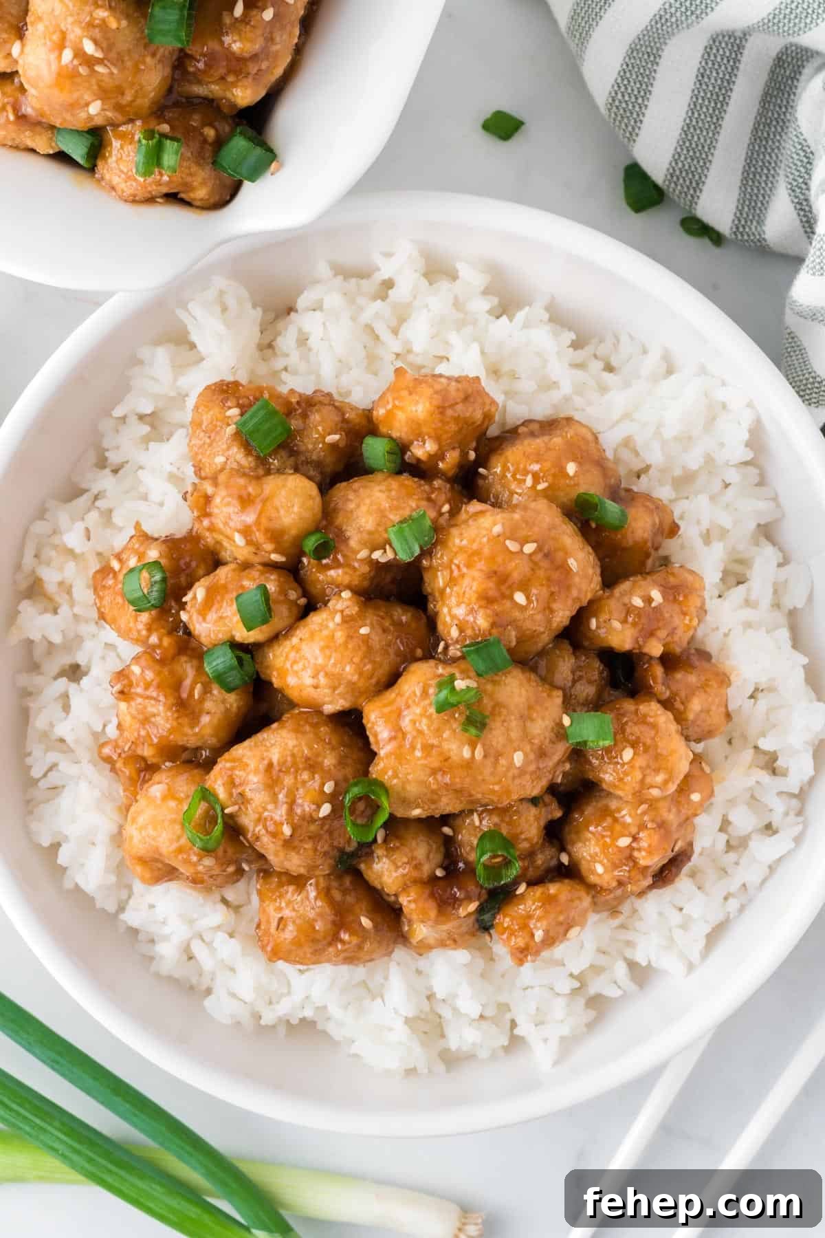 Sticky Teriyaki Cauliflower Bites with Sesame and Scallions 15 teriyaki cauliflower over rice in a white bowl