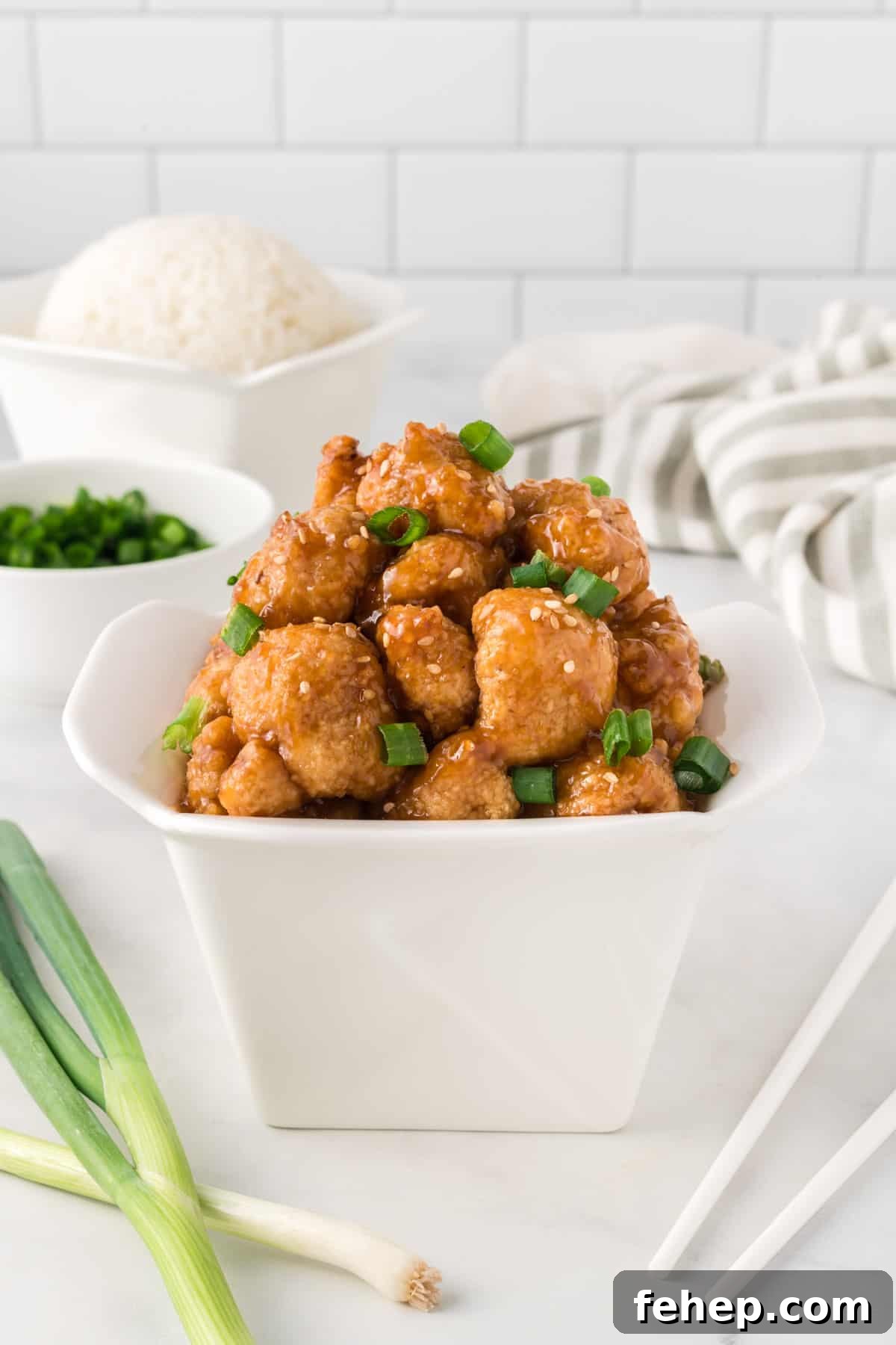 Sticky Teriyaki Cauliflower Bites with Sesame and Scallions 16 teriyaki cauliflower in a takeout container