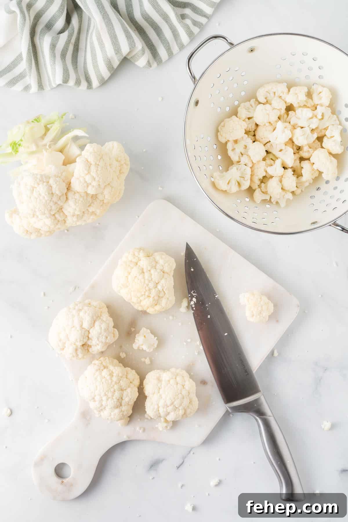 Sticky Teriyaki Cauliflower Bites with Sesame and Scallions 5 cutting board with cauliflower being cut with a knife