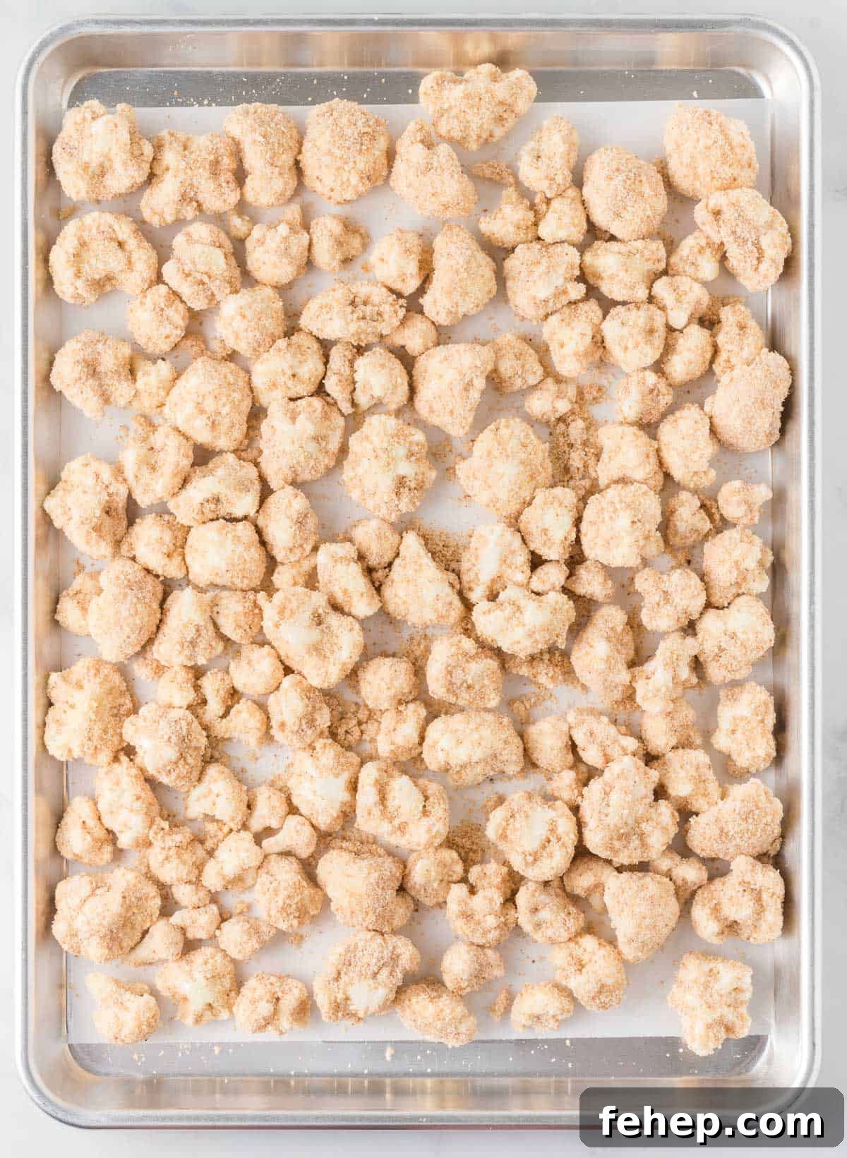 Sticky Teriyaki Cauliflower Bites with Sesame and Scallions 8 breaded cauliflower on a baking sheet