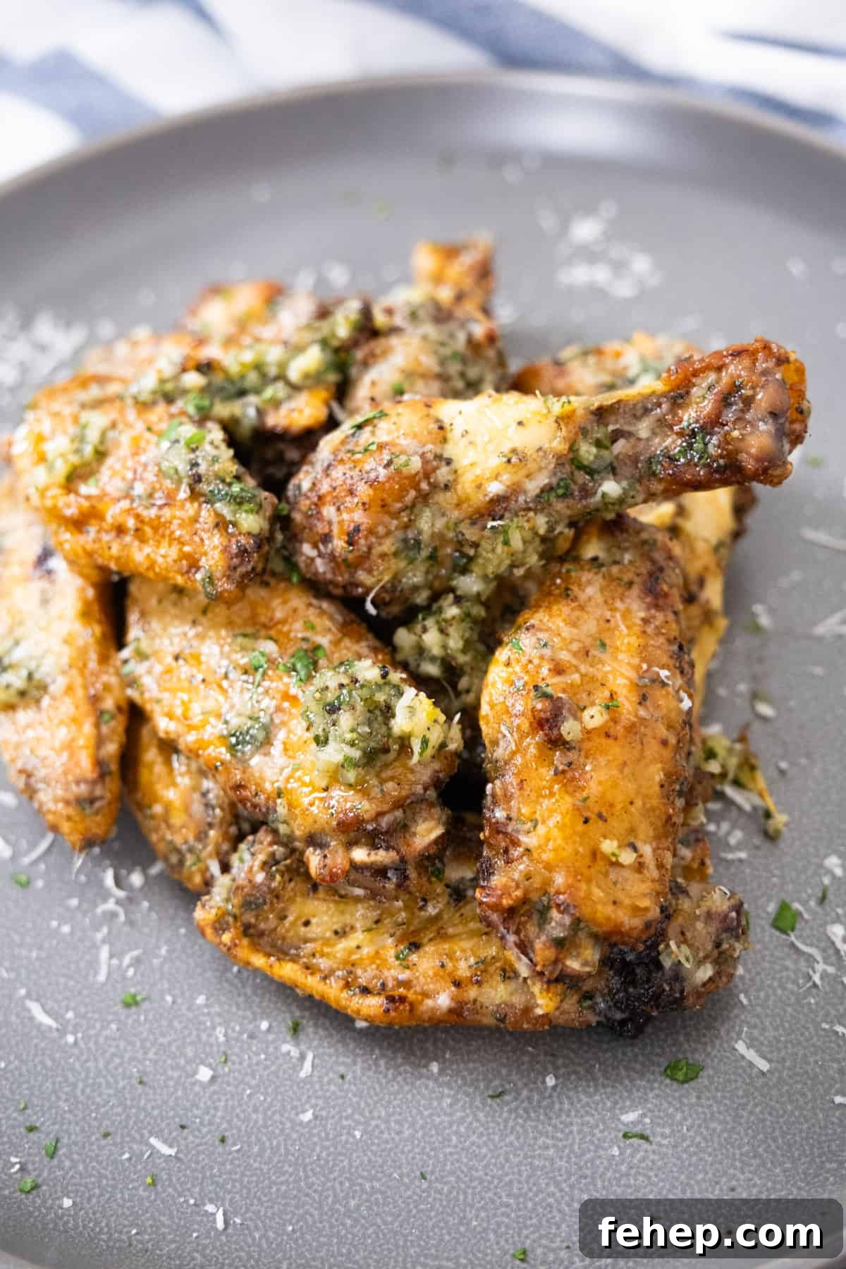 Crispy Air Fryer Garlic Parmesan Chicken Wings 2 air fryer garlic parm wings garnished with parsley