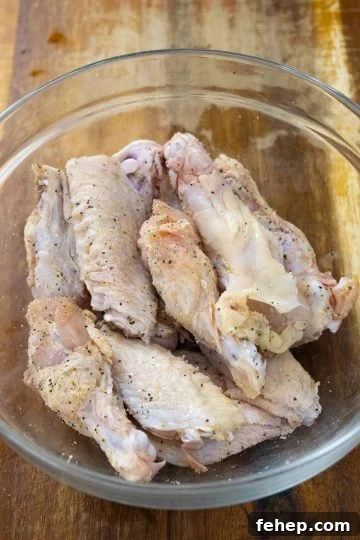 Crispy Air Fryer Garlic Parmesan Chicken Wings 4 seasoning wings in a bowl
