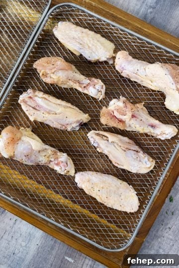 Crispy Air Fryer Garlic Parmesan Chicken Wings 5 wings going into air dryer
