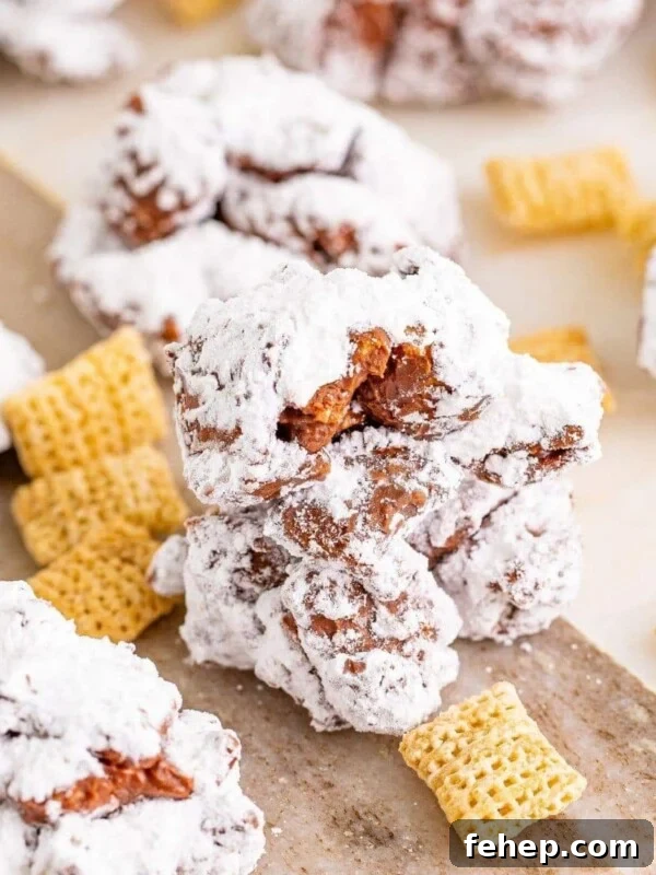 picture of muddy buddy cookies stacked on a wood cutting board