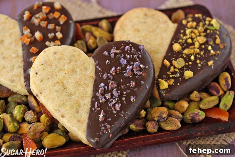 Pistachio Shortbread Cookies Pistachio Shortbread Cookies - Three cookies displayed on a tray with pistachios. | From SugarHero.com
