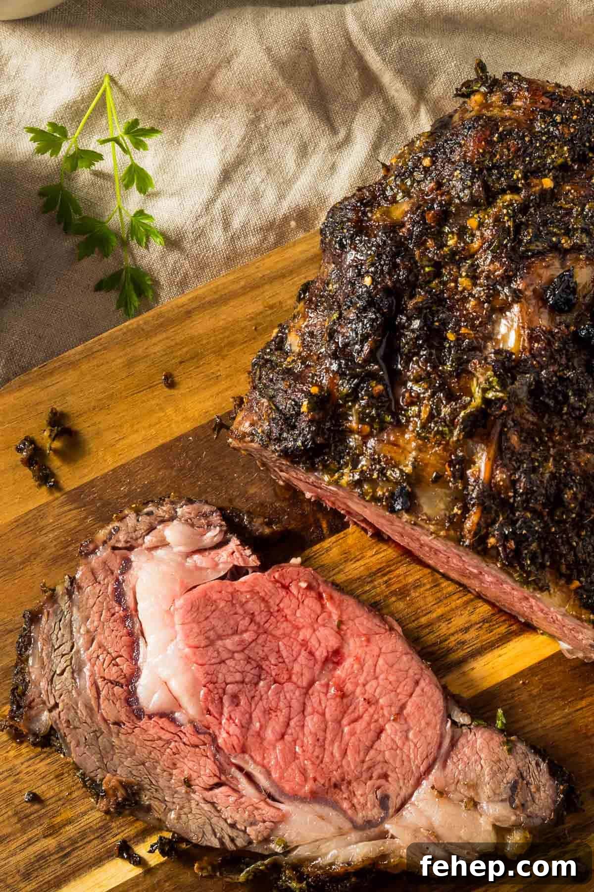 Garlic-Herb Crusted Boneless Prime Rib Recipe 3 a closeup of a boneless prime rib just out of the oven resting on a wooden cutting board