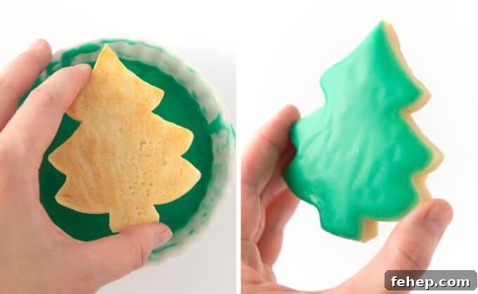 hand dipping sugar cookie in green icing glaze
