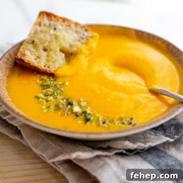 Vegetable potage soup in a bowl with a spoon.