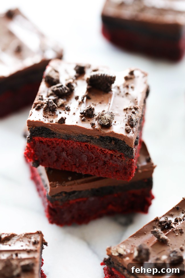 Red Velvet Oreo Truffle Brownies Recipe for Decadent Dessert 4 Slices of Red Velvet Oreo Truffle Brownies with glossy chocolate top