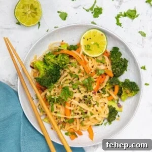 peanut butter noodles with vegetables in a bowl.