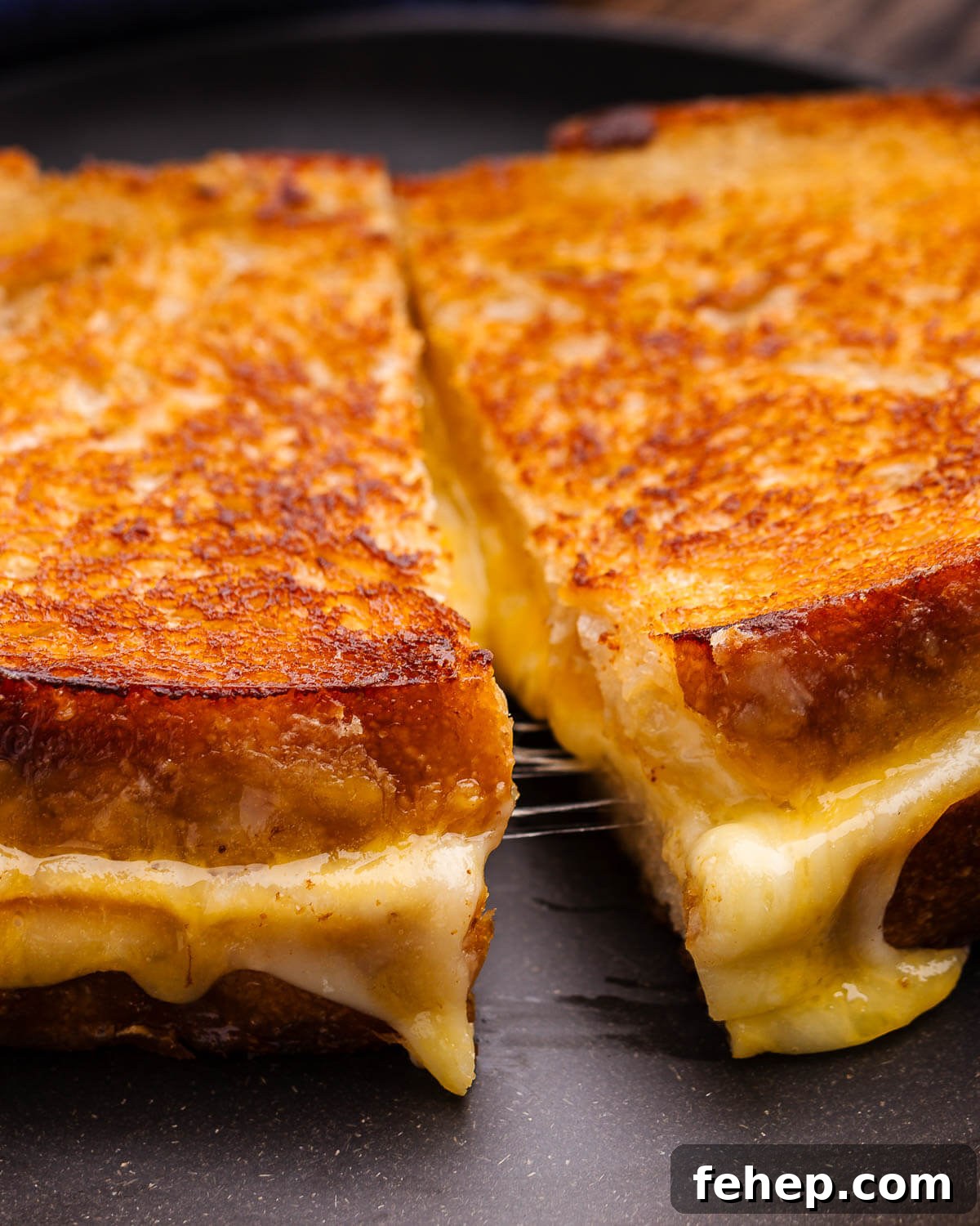 Closeup shot of sliced sourdough grilled cheese.
