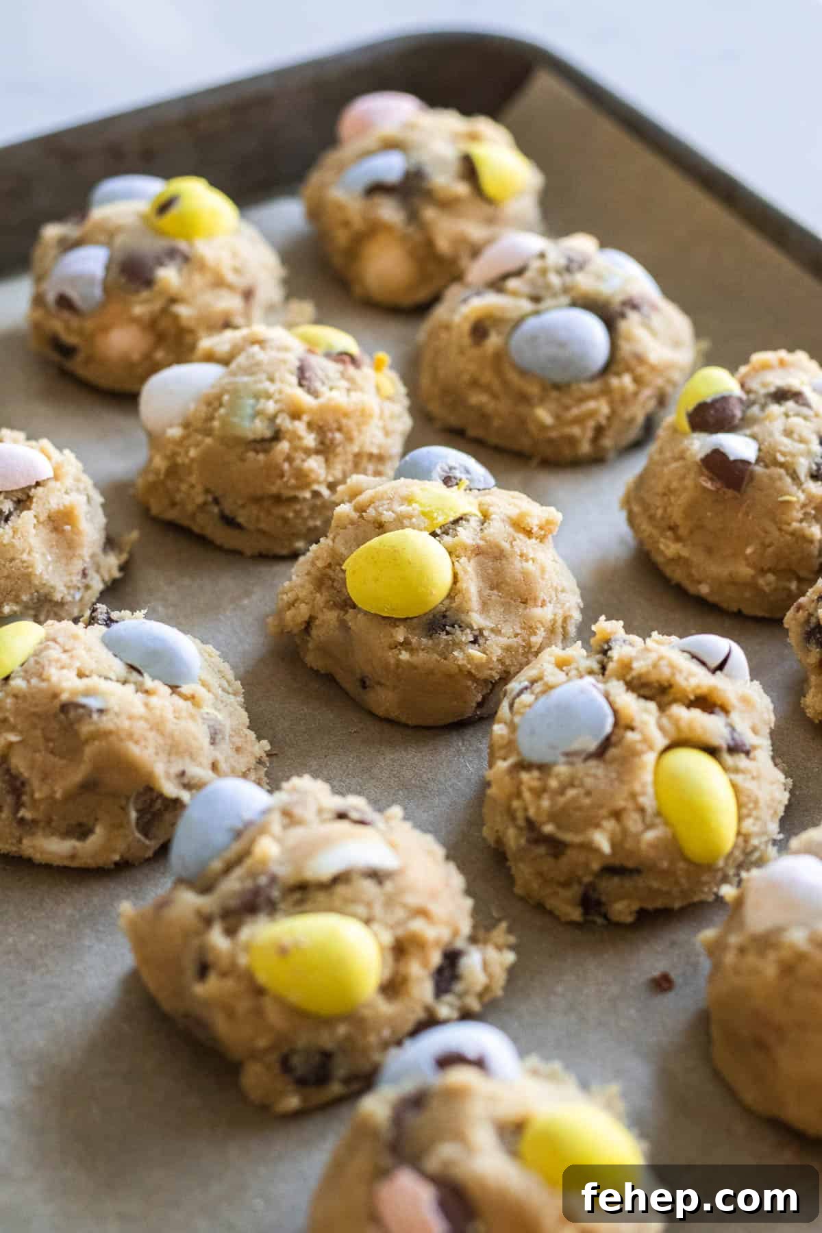 balls of cookie dough with mini egg candies on top