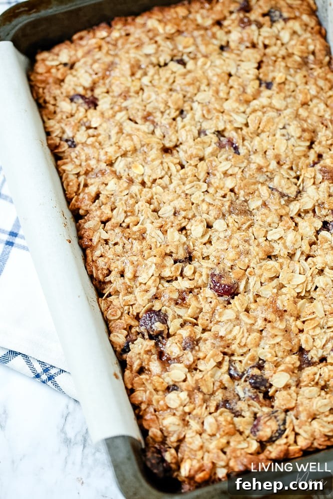 Cranberry Granola Bar Squares are a nutritious, moist, chewy granola bar square filled with oats, crispy rice, and dried cranberries. This is an easy, delicious, gluten-free and dairy-free snack recipe kids love!