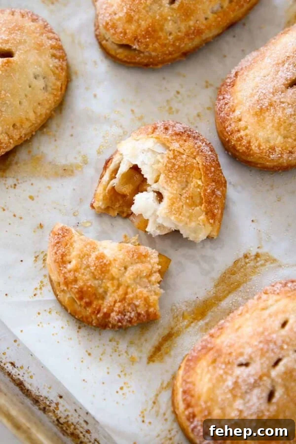 Mini Apple Hand Pies: Flaky Pocket Pies with Cinnamon Filling 14 apple hand pies baked on sheet pan.