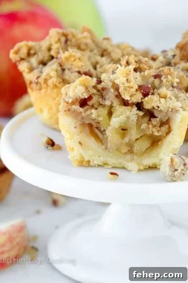 Mini Apple Hand Pies: Flaky Pocket Pies with Cinnamon Filling 17 mini apple pies on white cake stand.