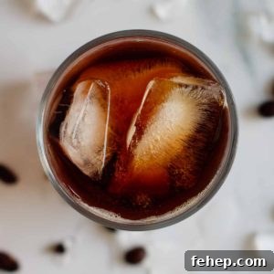 Cold Brew Coffee Concentrate: Ratios, Methods, and Pro Tips 13 cold brew coffee in a glass full with ice seen from above